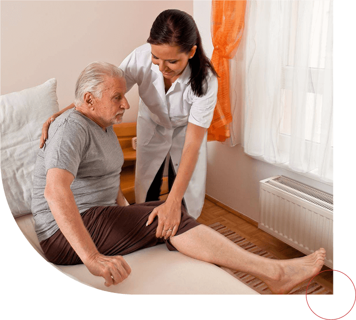 Nurse helping senior man to get down from bed