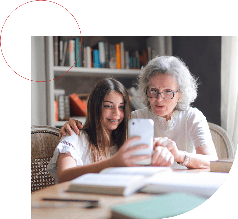 Little girl studying with old lady using mobile.