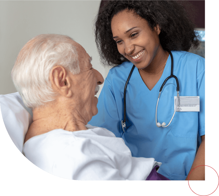 Nurse smiling at the patient lying in bed